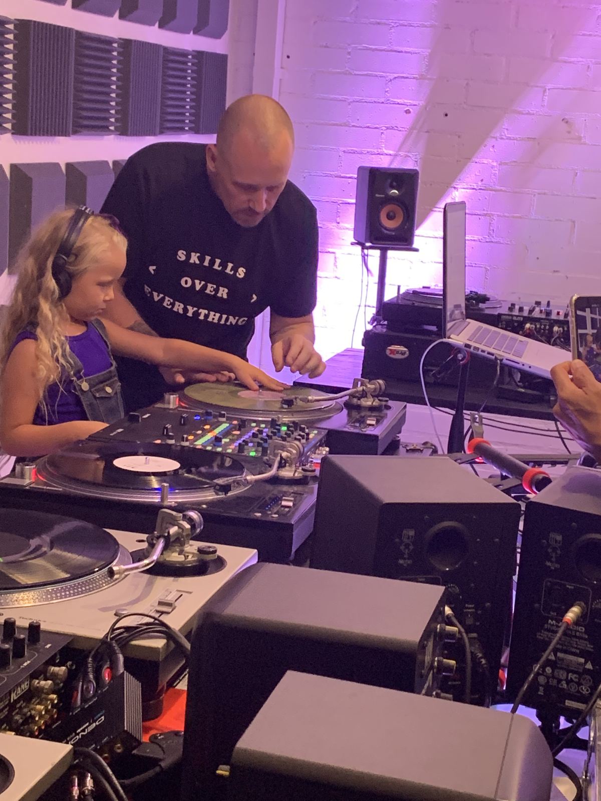 DJ Revolution teaching his daughter to scratch